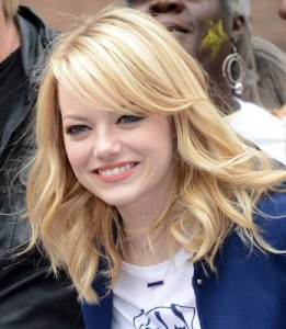Here, Emma Stone, a classic round faced woman, demonstrates how longer layers and side-swept bangs complement a rounder face. 